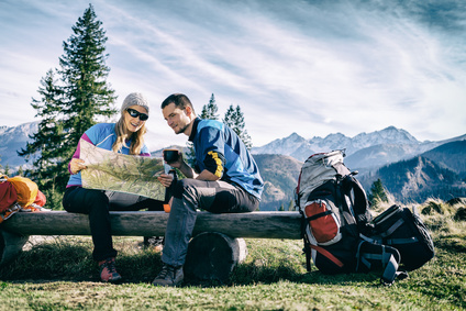 Couple hikers with map vintage retro mountains