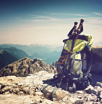 Backpack or rucksack balanced against a rock on top of a mountain summit in the Alps, Hochvogel, Germany, conceptual of a healthy, active outdoor lifestyle and sport