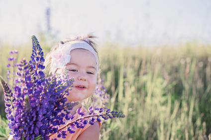 little girl with flowers outdoor